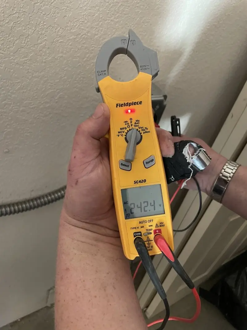 Voltage testing with clamp meter during Ceiling Fan Installation in Sturtevant